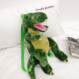 Sac à dos original dinosaure 3D vert dans un lit blanc