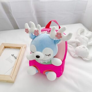 Pink plush school backpack in a white bed with a white plush on the side