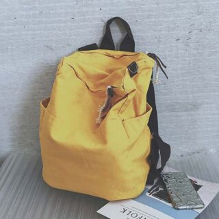 Yellow canvas backpack with blue background