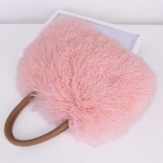 Fur and artificial leather handbag in pink with white background