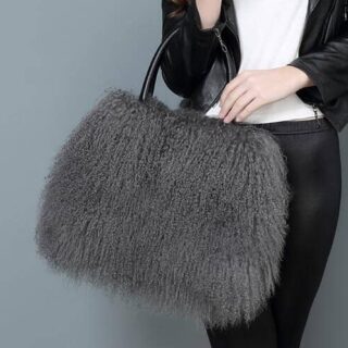 Handbag in fur and grey artificial leather with a background a woman carrying the bag and a grey background