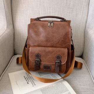 Brown leatherette vintage backpack with beige sofa background