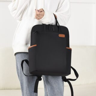 Waterproof backpack for businesswomen in black with a dummy holding the bag