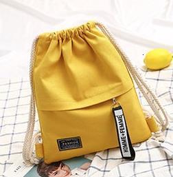 Women's yellow canvas backpack with white background