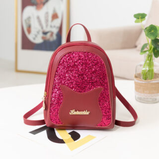 Mini sequin backpack for girl in burgundy with photo frame on a table in a house