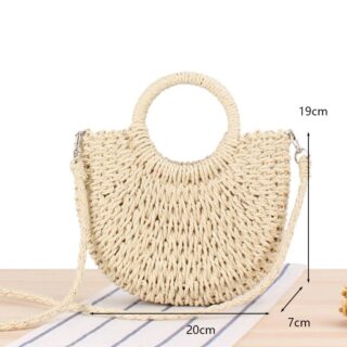 Beige women's summer straw shoulder bag with a wooden table bottom